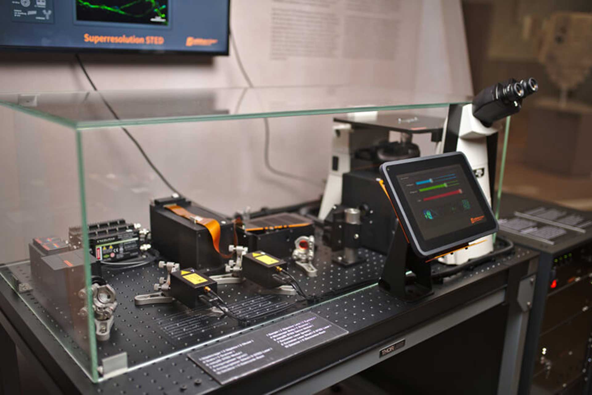 Transparent STED microscope as part of an exhibition with interactive surface